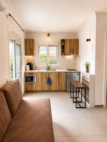 a kitchen with a couch and a table in a room at Panagiotis' Seaside Apartment, Giorgos`House in Gialova