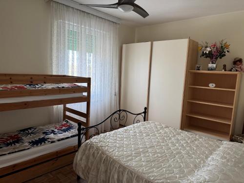 a bedroom with a bunk bed and a window at Casa di Nonni in I Forti