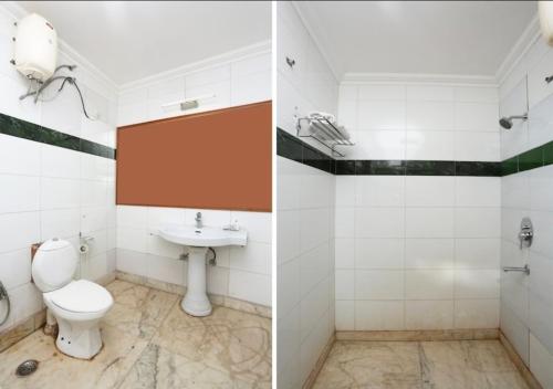 a bathroom with a toilet and a sink at The Avenue Residency in Gurgaon