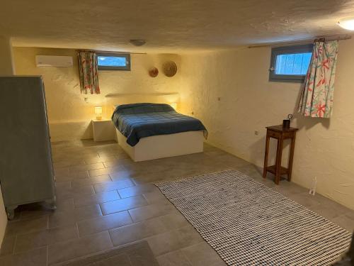 a bedroom with a bed in a room with a rug at Casa Luca in Drios