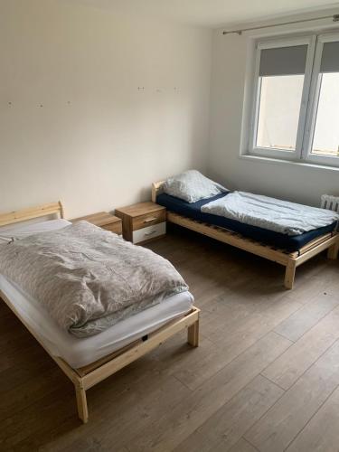 two twin beds in a room with a window at Your Home 27 with parking in Myslava