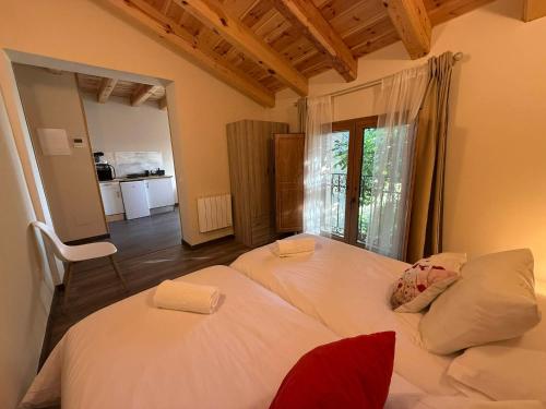 a bedroom with two beds and a large window at El Bulín de Prádena - Calle Real in Prádena del Rincón