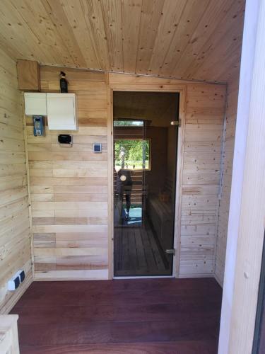 a inside view of a wooden cabin with a door at Domek letniskowy - żółty-całoroczny in Stegers