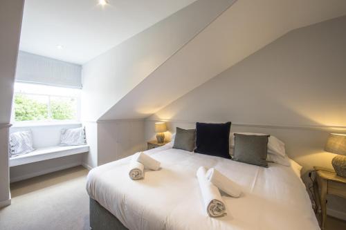 a bedroom with a white bed with two towels on it at The Fox Inn in Ansty