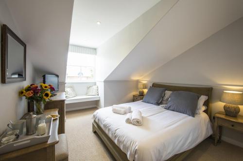 a bedroom with a large white bed and a sink at The Fox Inn in Ansty