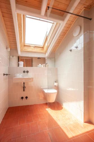 a bathroom with a toilet and a sink and a window at La Rogeta in Tabarca