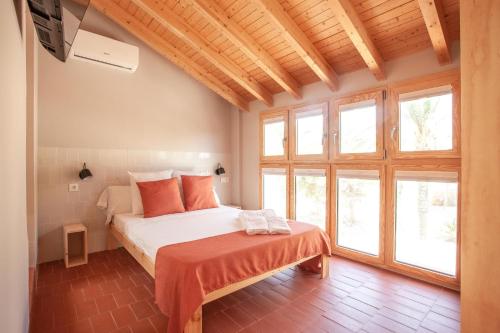 a bedroom with a bed in a room with windows at La Rogeta in Tabarca