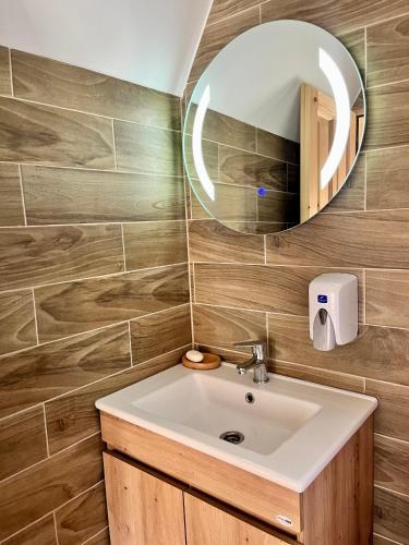 a bathroom with a sink and a mirror at Eco Lux Prokletije resort in Gusinje