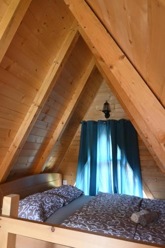 a bedroom with a bed in a attic at Eco Lux Prokletije resort in Gusinje