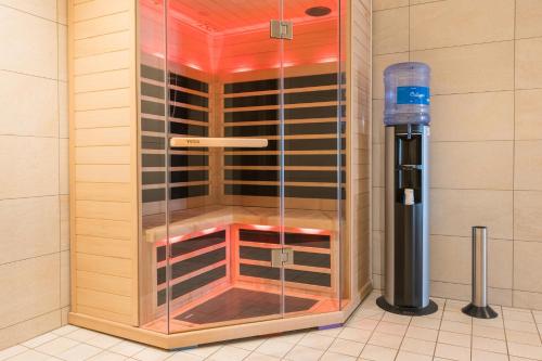 a shower in a bathroom with a glass enclosure at Hartungs Hoteldorf in Füssen