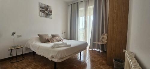 a bedroom with a bed in front of a window at A Casa Das Chocas in San Román