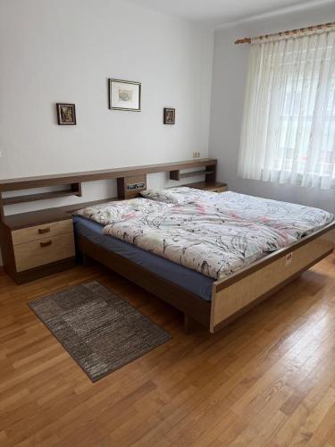 a bedroom with a bed and a wooden floor at Ferienwohnung Altes Rüsthaus in Ilz