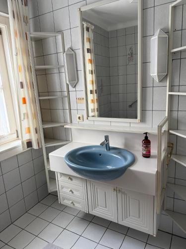 a bathroom with a sink and a mirror at Ferienwohnung Altes Rüsthaus in Ilz