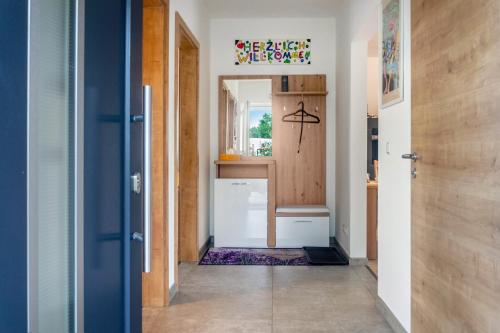 a hallway with a door leading to a kitchen at Fewo im Fränkischen Seenland in Abenberg