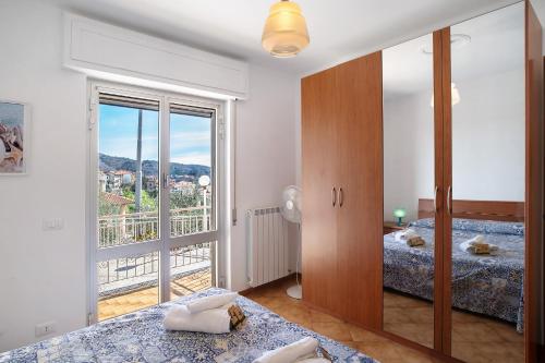 a bedroom with two beds and a large window at Paola in Villa Faraldi