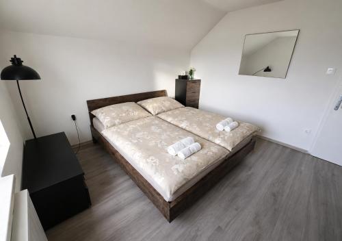 a bedroom with a bed with two pillows on it at Apartment Čebelica in Lesce