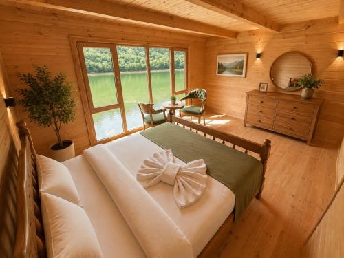 a bedroom with a bed with a bow on it at Buneba Resort in Borçka