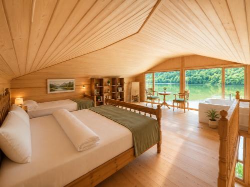 a bedroom with a large bed and a large window at Buneba Resort in Borçka