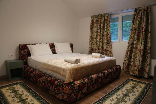 a bedroom with a bed with two pillows on it at Lala Resort in Kolgecaj