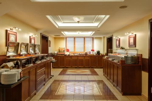 a large kitchen with wooden counters and a large window at Rixwell Old Riga Palace Hotel in Riga