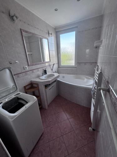 a bathroom with a tub and a sink and a bath tub at 3 room apartment in Trnava