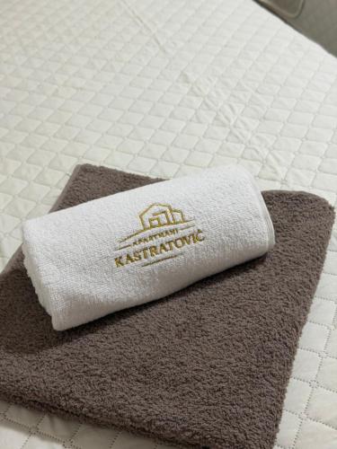 a towel sitting on top of a bed at Apartmani Kastratovic in Golubovci