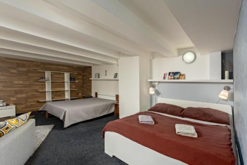 a bedroom with a large bed and a couch at Penzion Miromar in Podivín
