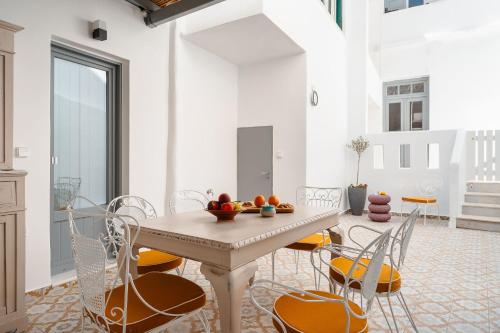 a dining room with a table and chairs at CASA DE SAL in Naxos Chora