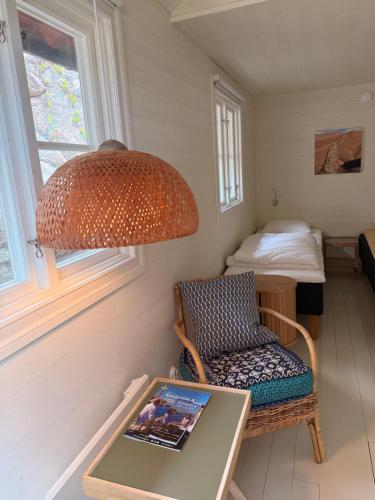 a room with a table and a chair and a lamp at Hem till Bengt in Kungshamn