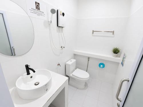 a white bathroom with a sink and a toilet at Dive In Koh Tao in Ko Tao