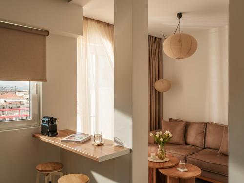 a living room with a couch and a table at Deos- Luxury Apartment in Agrinio in Agrinio