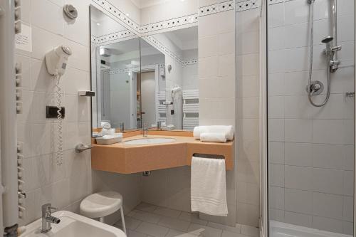 a bathroom with a sink and a shower at Hotel Sirena & Cucina in Cesenatico