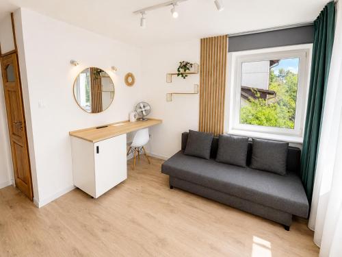 a living room with a couch and a window at B&B Fajne Miejsce in Łeba