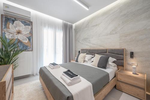 a bedroom with a king sized bed and a plant at West Athens Luxurius Apartment in Athens