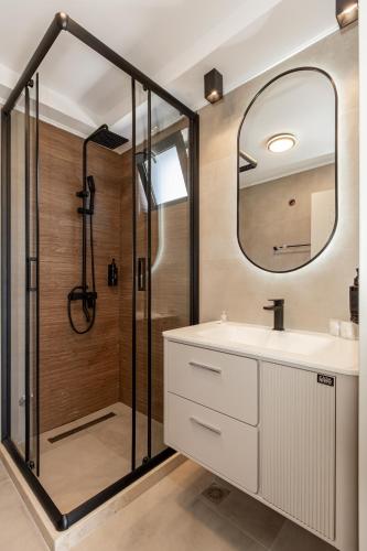 a bathroom with a shower and a sink and a mirror at FKK Ada Bojana in Ulcinj