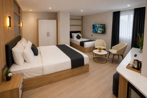 a hotel room with two beds and a bathroom at Golden River Hotel By Continent in Arnavutköy