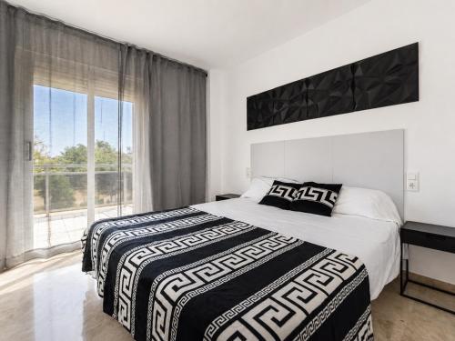 a bedroom with two beds and a large window at Ventura Park CC3 in Salou