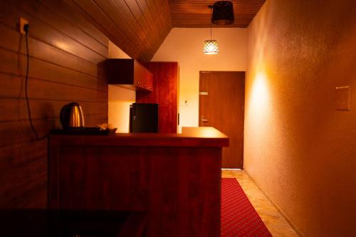 a room with a kitchen with a counter and a hallway at West Bay Palm Tree Beach Resort in Varkala