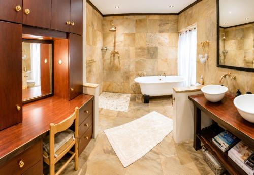 a bathroom with a tub and a sink and a bath tub at Ladera - Vista Self-catering Guesthouse in Paarl