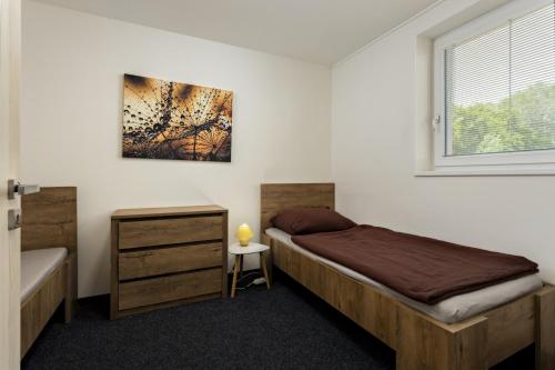 a bedroom with a bed and a window at Apartmány Miromar in Podivín