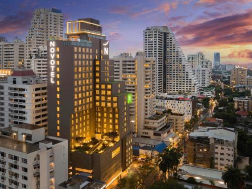 a city skyline with tall buildings at night at ibis Styles Bangkok Sukhumvit 4 in Bangkok