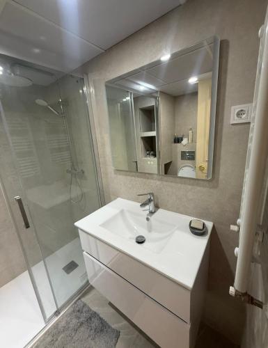 a bathroom with a white sink and a shower at Casa val in Valdemoro