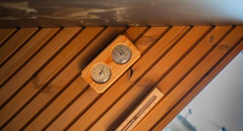 two clocks sitting on top of a wooden table at Moonloungeresort in Kalviai