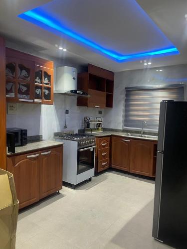 a kitchen with a blue light in the ceiling at Three bedroom apartment Magodo GRA in Magodo