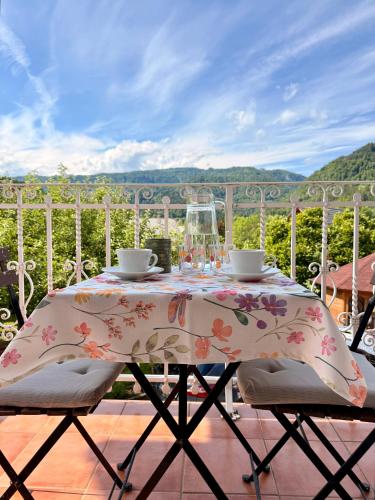 a table with a floral table cloth on a balcony at Apartments Gorje Hideaway in Spodnje Gorje