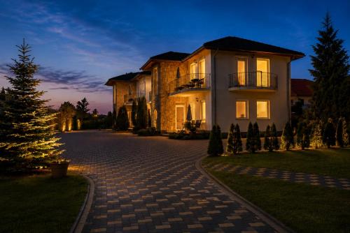a large house with a christmas tree in front of it at Balatonlelle Apartmanház in Balatonlelle
