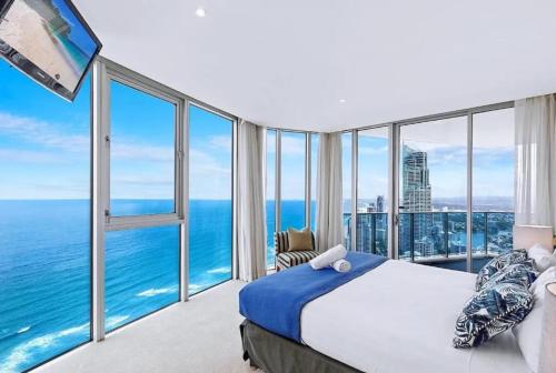 a bedroom with a bed and views of the ocean at Luxurious 2 Bedroom Apartment - Ocean View in Gold Coast