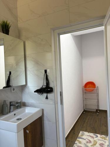 a bathroom with a sink and a mirror at Vila Vavilon in Star Dojran