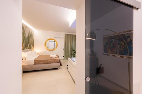 a bedroom with a bed and a mirror at Tortugas B&B in Giarre