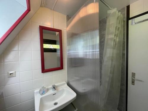 a bathroom with a sink and a glass shower at Feriendorf Sulzfeld in Sulzfeld